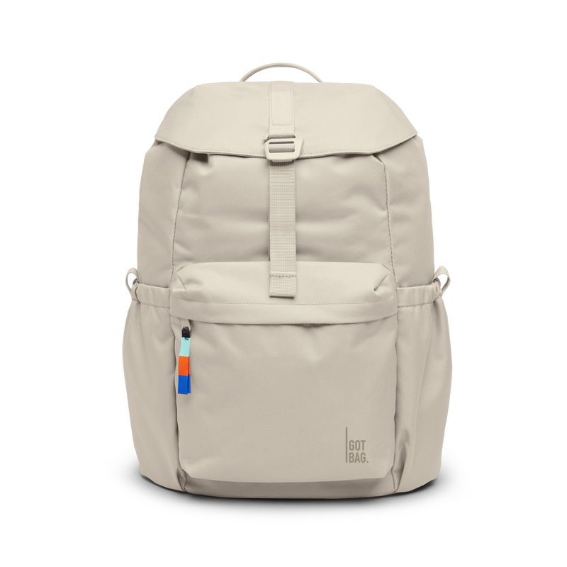 FLAP PACK backpack in soft shell (Warm Cream White), studio shot, front view.