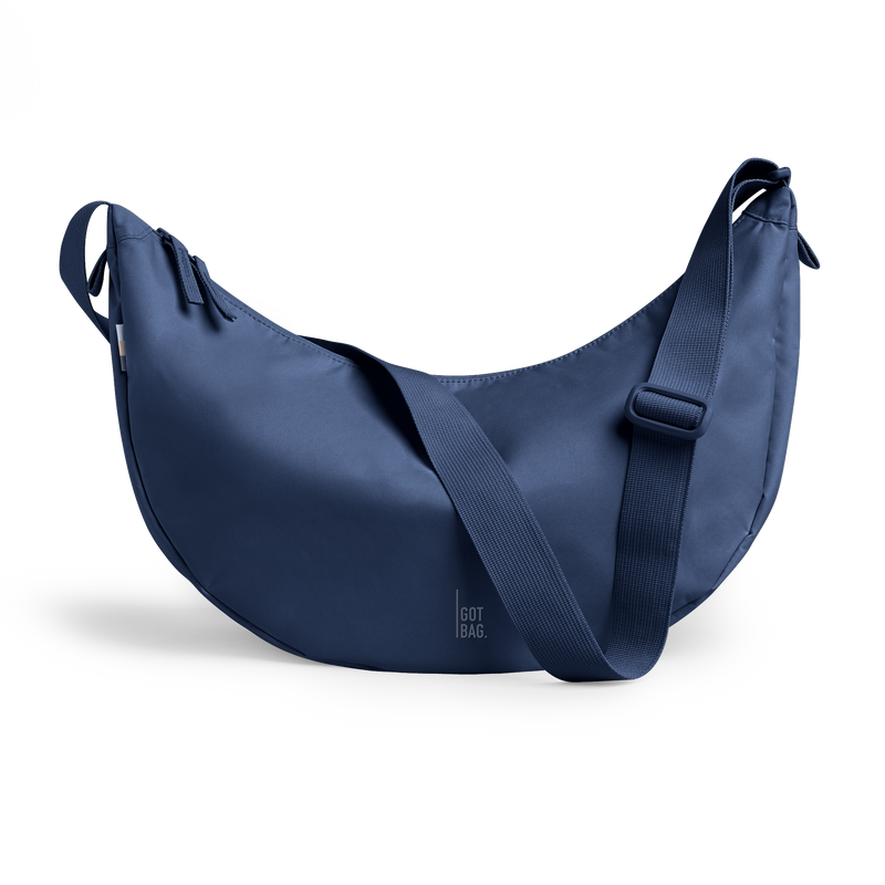 MOON BAG LARGE bag in deep ocean (Dark Navy Blue), studio shot, front view.