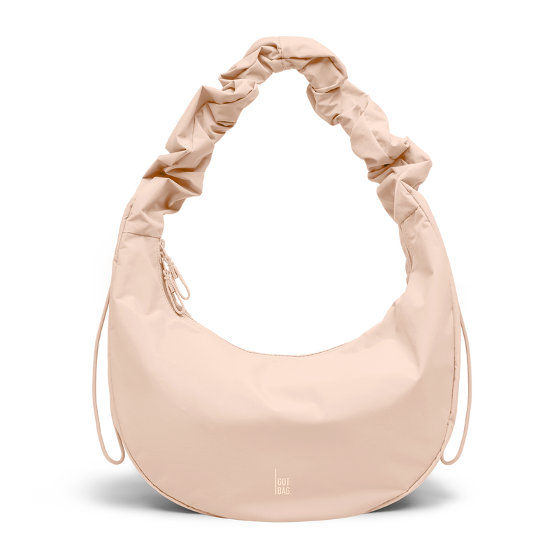 MOON BAG RUFFLE bag in pearl (Light Powder Pink), studio shot, front view.