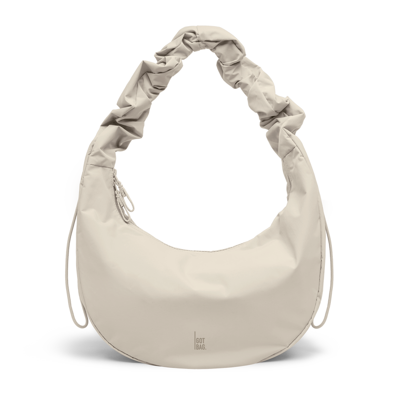 MOON BAG RUFFLE bag in soft shell (Warm Cream White), studio shot, front view.