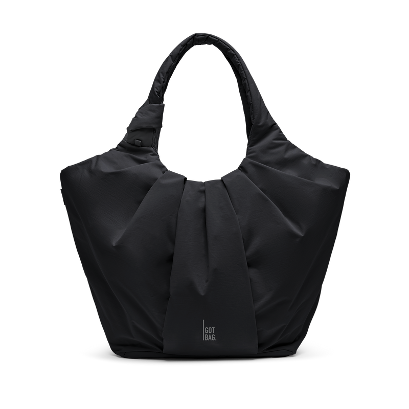 PLEAT TOTE BAG bag in black (Black), studio shot, front view.